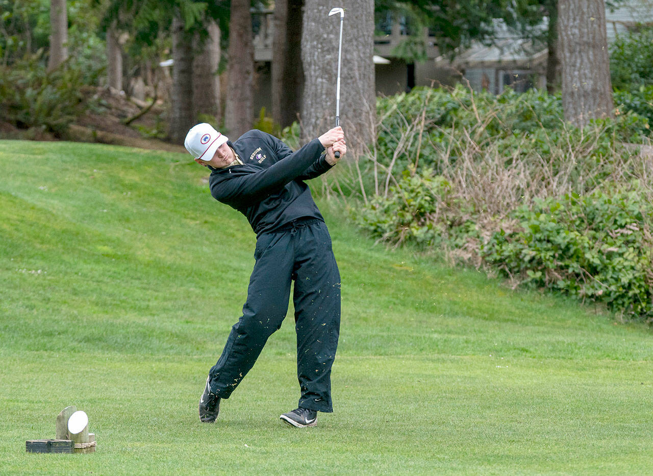 Sequim’s Dom Riccobene drives the ball with an iron on the second hole at Port Ludlow Golf Course during a match Thursday against the North Kitsap Vikings. (Steve Mullensky/for Peninsula Daily News)