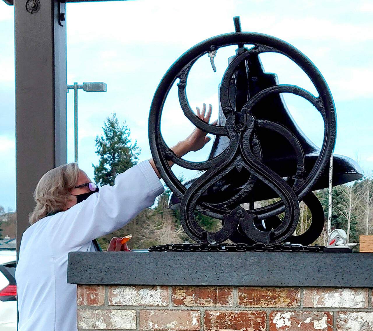 Pastor Joey Olsen blesses the 19th-century bell at Trinity United Methodist Church in February. (Courtesy photo)