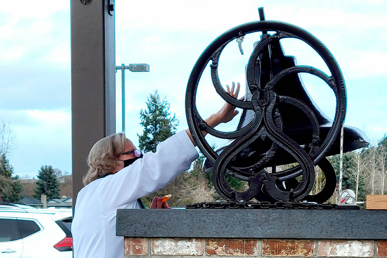 Pastor Joey Olsen blesses the 19th-century bell at Trinity United Methodist Church in February. (Courtesy photo)