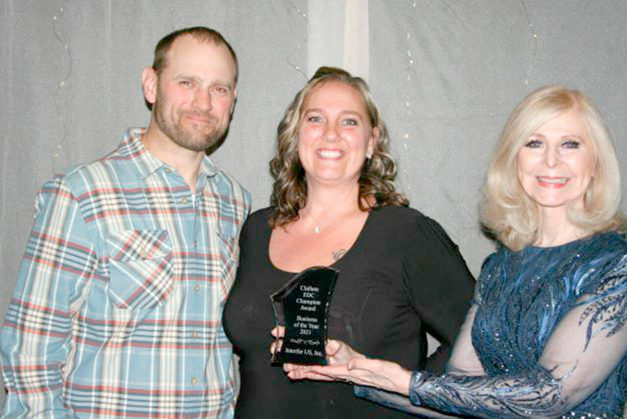 Accepting the Clallam Economic Development Council Champion Award Business of the Year award from Cherie Kidd of AAA Affordable Storage, award sponsor, right, were Interfor US, Inc.’s management team members Tyril Spence, left, and Chandra McGoff.