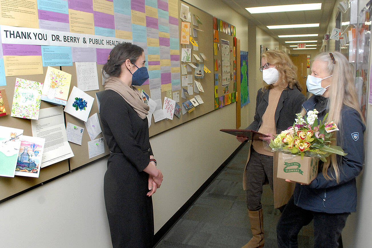 Allison Berry, public health officer for Clallam and Jefferson counties, left, talks with Marcia Limoges, center, and Bonnie Bless-Boenish of the League of Women Voters of Clallam County before presenting Berry with the organization’s annual “Making a Difference Award” on Tuesday in Port Angeles. Presented in celebration of women’s contributions to history and coinciding with Women’s History Month, the award was given to Berry for her contributions to public health during the COVID-19 pandemic. (Keith Thorpe/Peninsula Daily News)