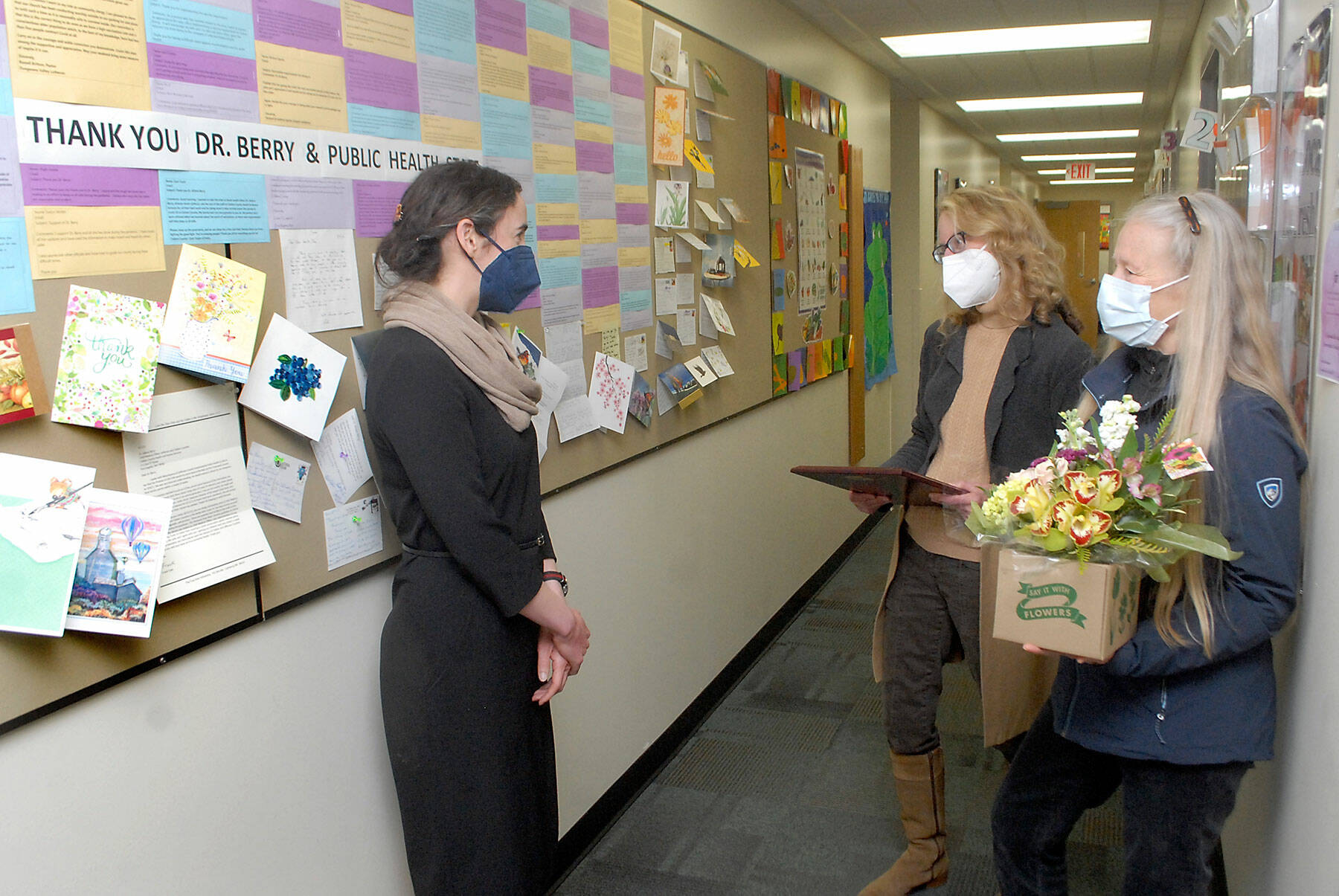 Allison Berry, public health officer for Clallam and Jefferson counties, left, talks with Marcia Limoges, center, and Bonnie Bless-Boenish of the League of Women Voters of Clallam County before presenting Berry with the organization’s annual “Making a Difference Award” on Tuesday in Port Angeles. Presented in celebration of women’s contributions to history and coinciding with Women’s History Month, the award was given to Berry for her contributions to public health during the COVID-19 pandemic. (Keith Thorpe/Peninsula Daily News)