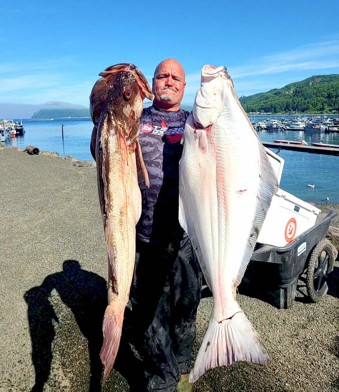 Olympic Chapter of Salmon for Soliders member Daniel Goettling caught this halibut and lingcod while fishing with a group of military veterans last summer. Halibut fishing begins April 7 in Marine Areas 6-10.