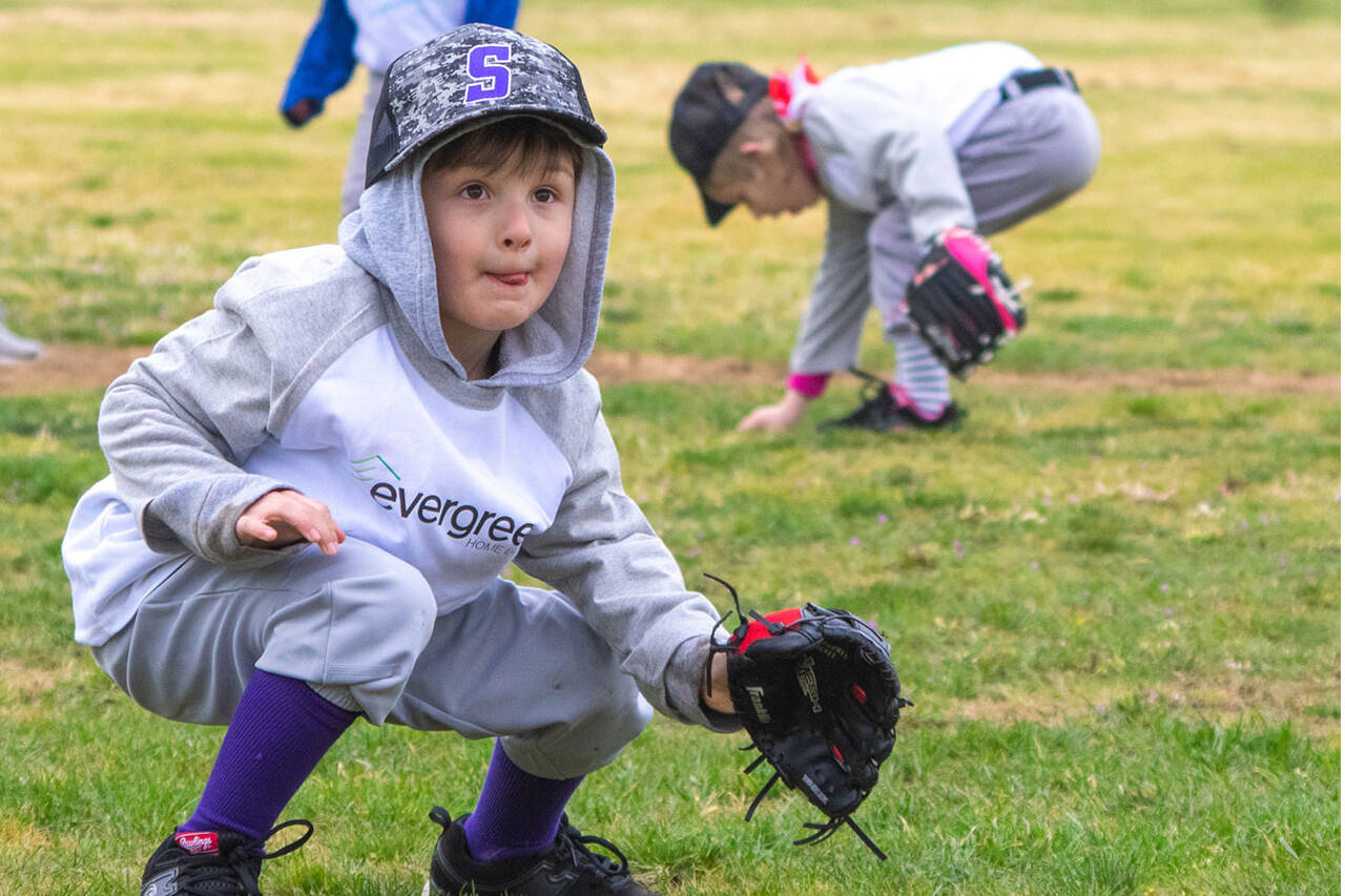 T-Ball player Dominic Johnson tries for a catch during opening day of the 2022 Sequim Little League.