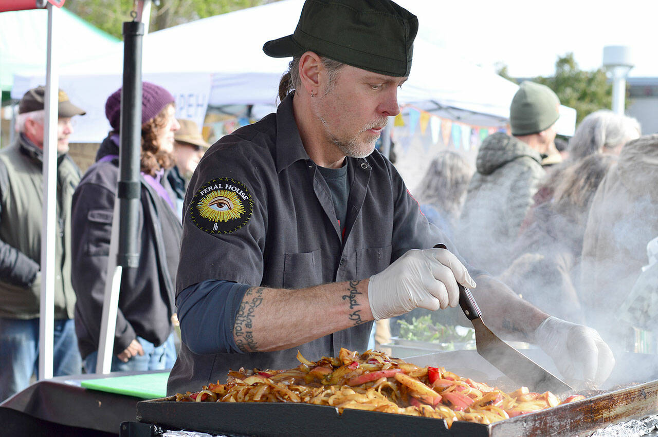 Barbarian Fine Cuisine's Chris Kauffman was among the numerous cooks working opening day of the Port Townsend market on Saturday. (Diane Urbani de la Paz/Peninsula Daily News)