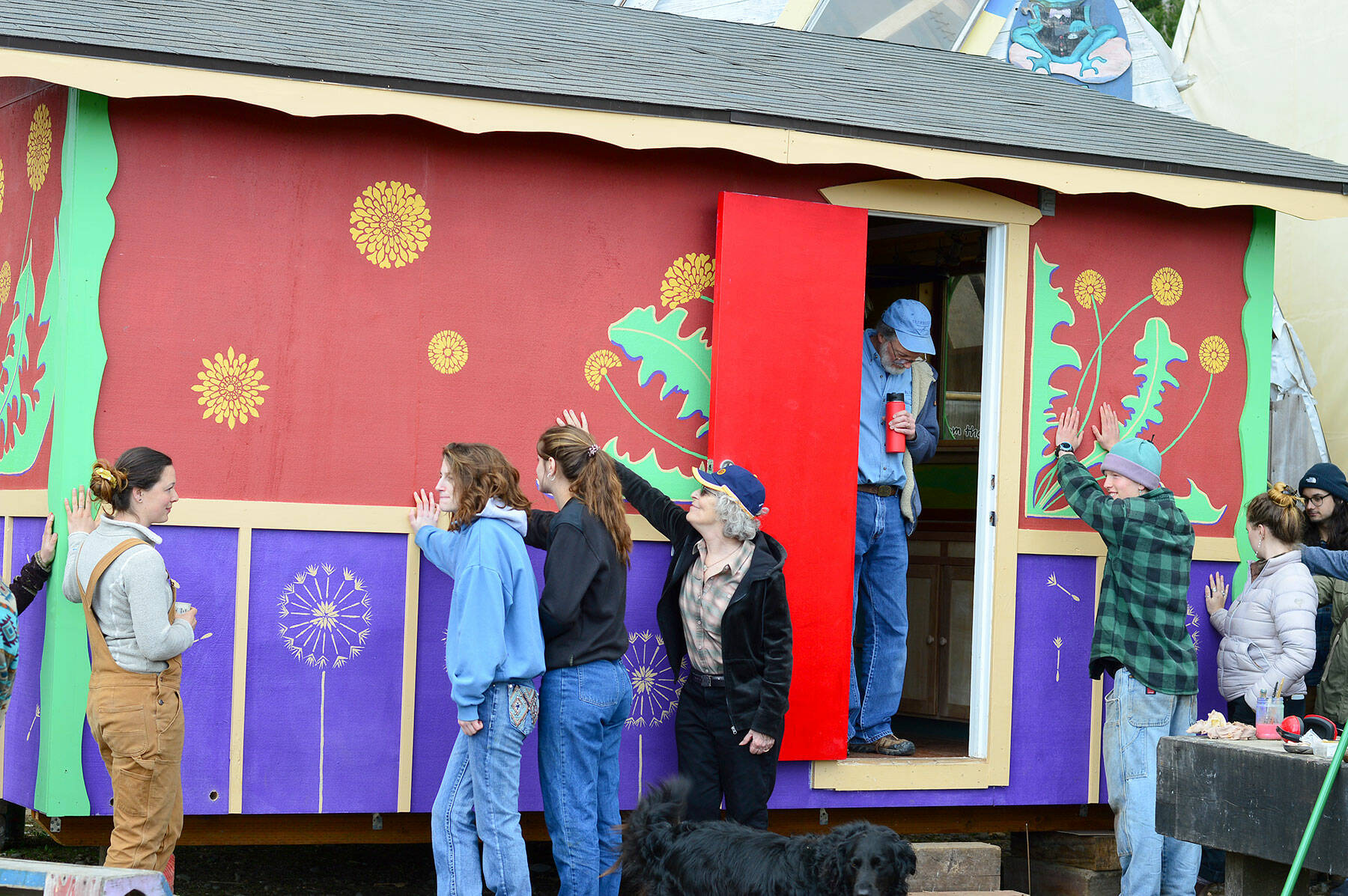 Several of the workers who built Meadow Manor, a tiny house destined for a farmworker village, celebrate its completion at the Community Boat Project last Friday. (Diane Urbani de la Paz/Peninsula Daily News)