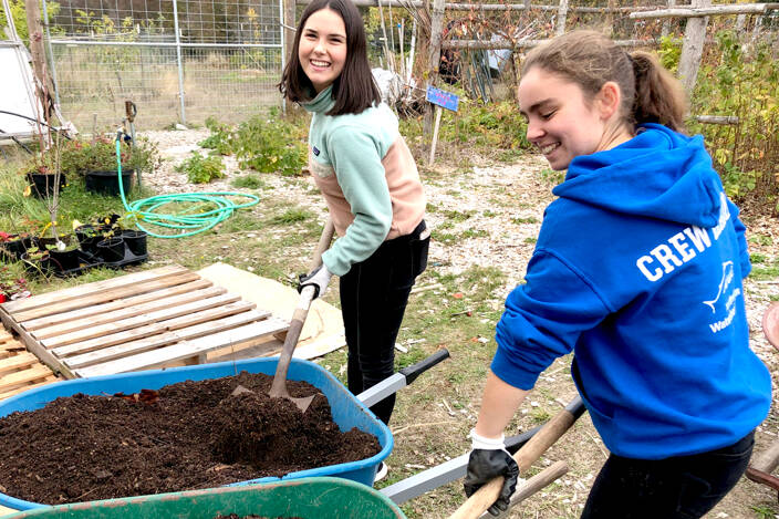 Student project manager Jeanette Patric, left, helps Hailey Gallagher shovel soil for native plants for their senior project — a remodel of Northwest Watershed Institute’s native plant nursery. (Northwest Watershed Institute)