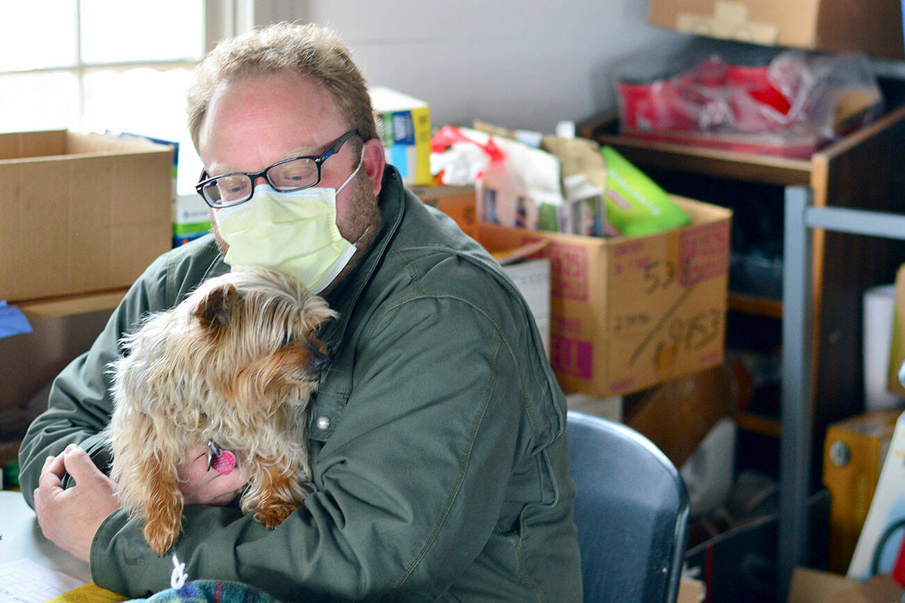 Ben Casserd keeps his terrier Half Pint close by as he manages downtown Port Townsend’s Winter Welcoming Center. (Diane Urbani de la Paz/Peninsula Daily News)