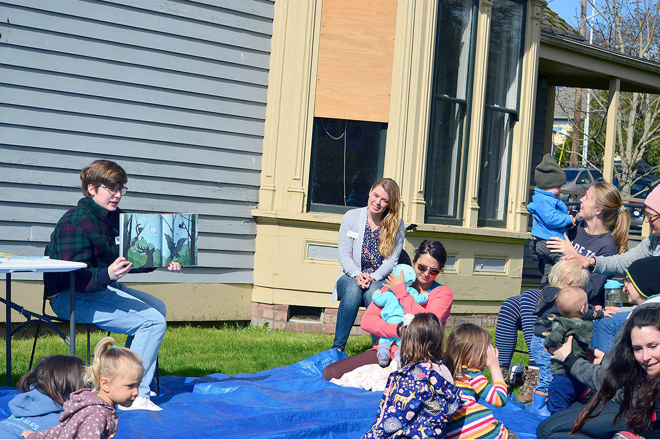 Librarians Paige Wynkoop, in chair at left, and Emily Bufford, in chair at center, host Tuesday morning story time outside the Port Townsend Library. Both library staffers are new and planning youth-oriented activities this spring and summer. (Diane Urbani de la Paz/Peninsula Daily News)