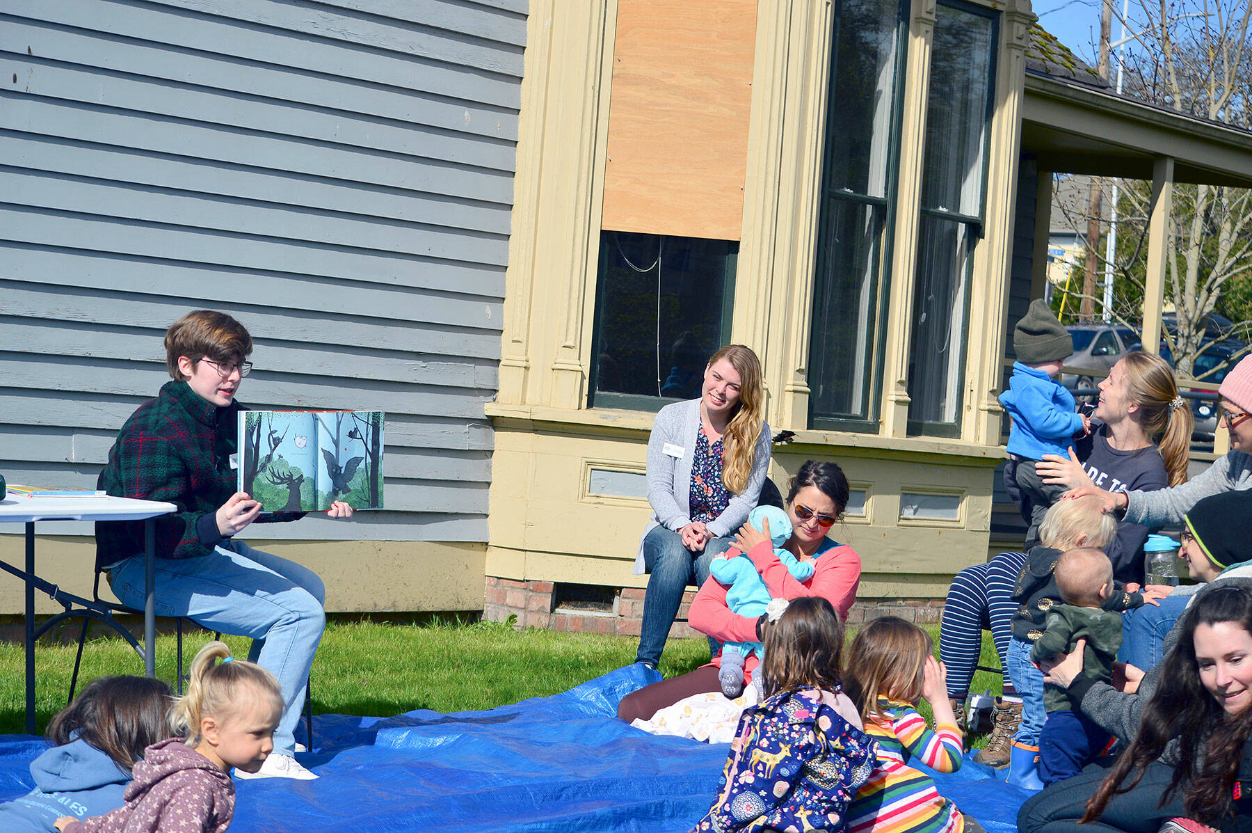 Librarians Paige Wynkoop, in chair at left, and Emily Bufford, in chair at center, host Tuesday morning story time outside the Port Townsend Library. Both library staffers are new and planning youth-oriented activities this spring and summer. (Diane Urbani de la Paz/Peninsula Daily News)
