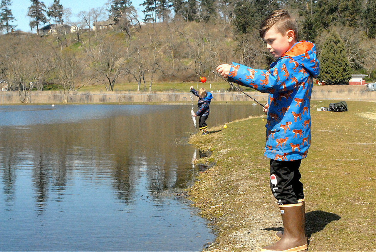 Weston Web, 6, prepares to cast a line at the children’s fishing pond at the Water Reuse Demonstration Site next to Carrie Blake Community Park in March 2021, as his brother, Bennet, 4, tends to a freshly caught fish. (Keith Thorpe/Peninsula Daily News)