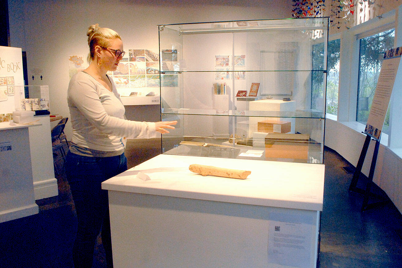 Rachel Storck, community engagement manager for the Port Angeles Fine Arts Center, points out a display case where exhibit pieces were taken during a weekend burglary. (Keith Thorpe/Peninsula Daily News)