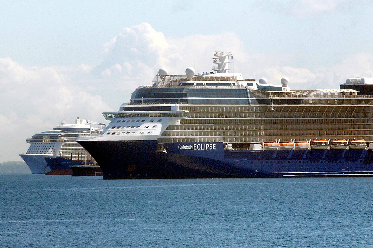 Keith Thorpe/Peninsula Daily News
The cruise ships Celebrity Eclipse, front, and Ovation of the Seas, rear, sit anchored in Port Angeles Harbor on Friday as they await the Alaskan cruise season. Both ships are operated by the Royal Caribbean Group or its subsidiaries. Anchored between the cruise vessels are the bulk carrier James Bay and the pusher tug Dublin Sea.