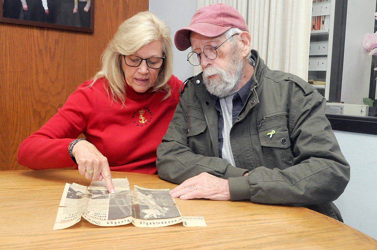 Vicki Parrish of Seven Bays near Davenport, left, discusses the circumstances of a 1987 plane crash she survived on Blyn Mountain with one of her rescuers, Robert Hamlin of Clallam County Search and Rescue, during a reunion in Port Angeles on Tuesday. (Keith Thorpe/Peninsula Daily News)