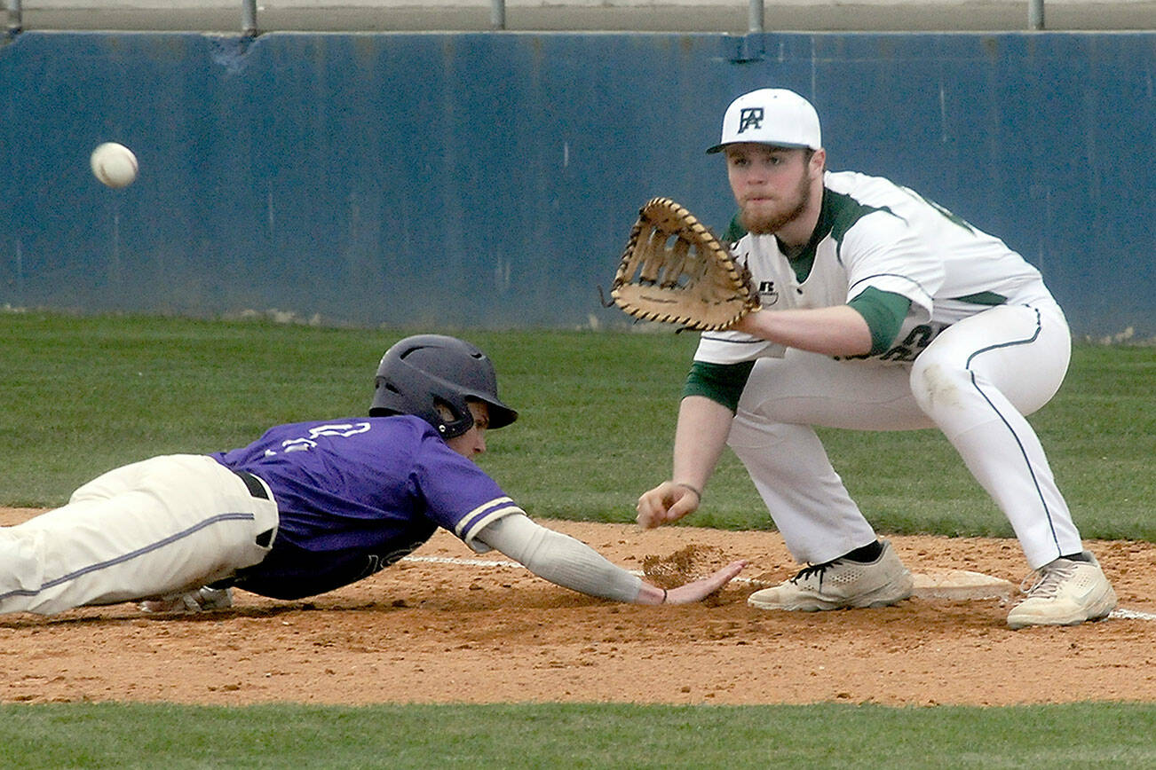 Keith Thorpe/Peninsula Daily News
Port Angeles first baseman Ezra Townsend, right, attempts to catch North Kitsap baserunner Zach Edwards off the bag during Wednesday's game at Port Angeles Civic Field.