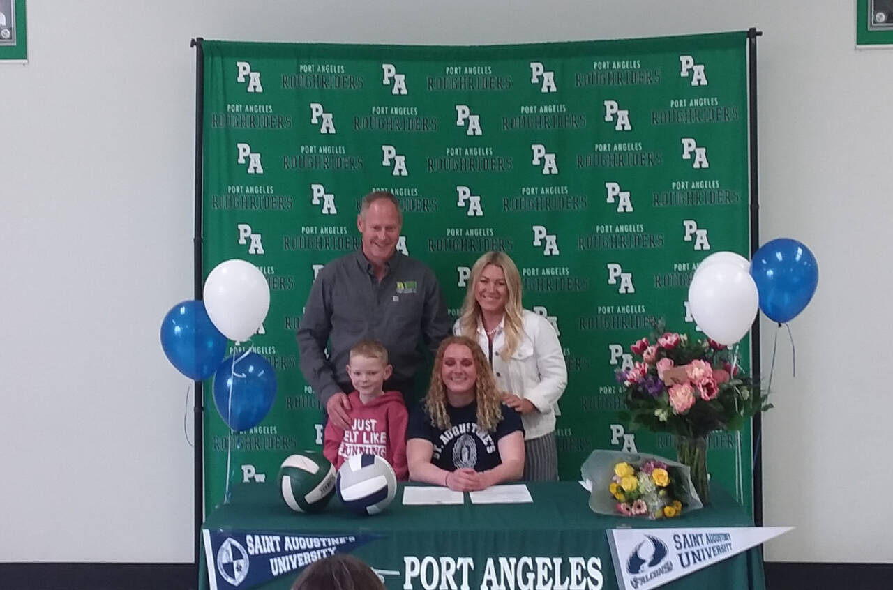 Kennedy Bruch signs a letter of intent to play volleyball and run track at St. Augustine’s College in Raleigh, N.C. with her father Jesse Bruch, mother Alissa Bruch and brother Jack Bruch. (Pierre LaBossiere/Peninsula Daily News)