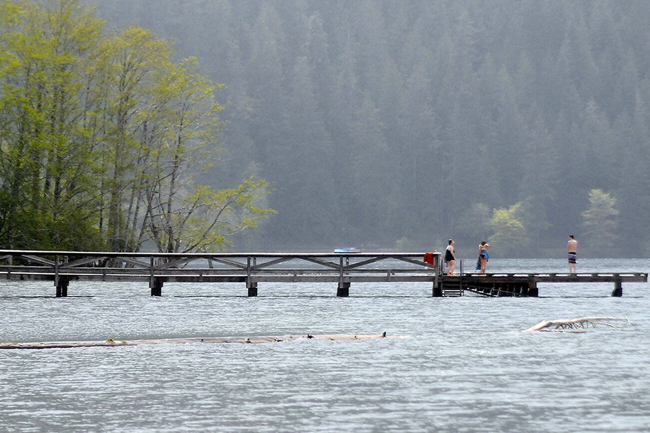 Keith Thorpe/Peninsula Daily News
Visitors to Lake Crescent Lodge at Barnes Point contemplate swimming from the lodge's dock on Tuesday in Olympic National Park southwest of Port Angeles. Lake Crescent is one of the parks most visited attractions, drawing thousands of visitors each year to marvel at the interface of mountains and water.