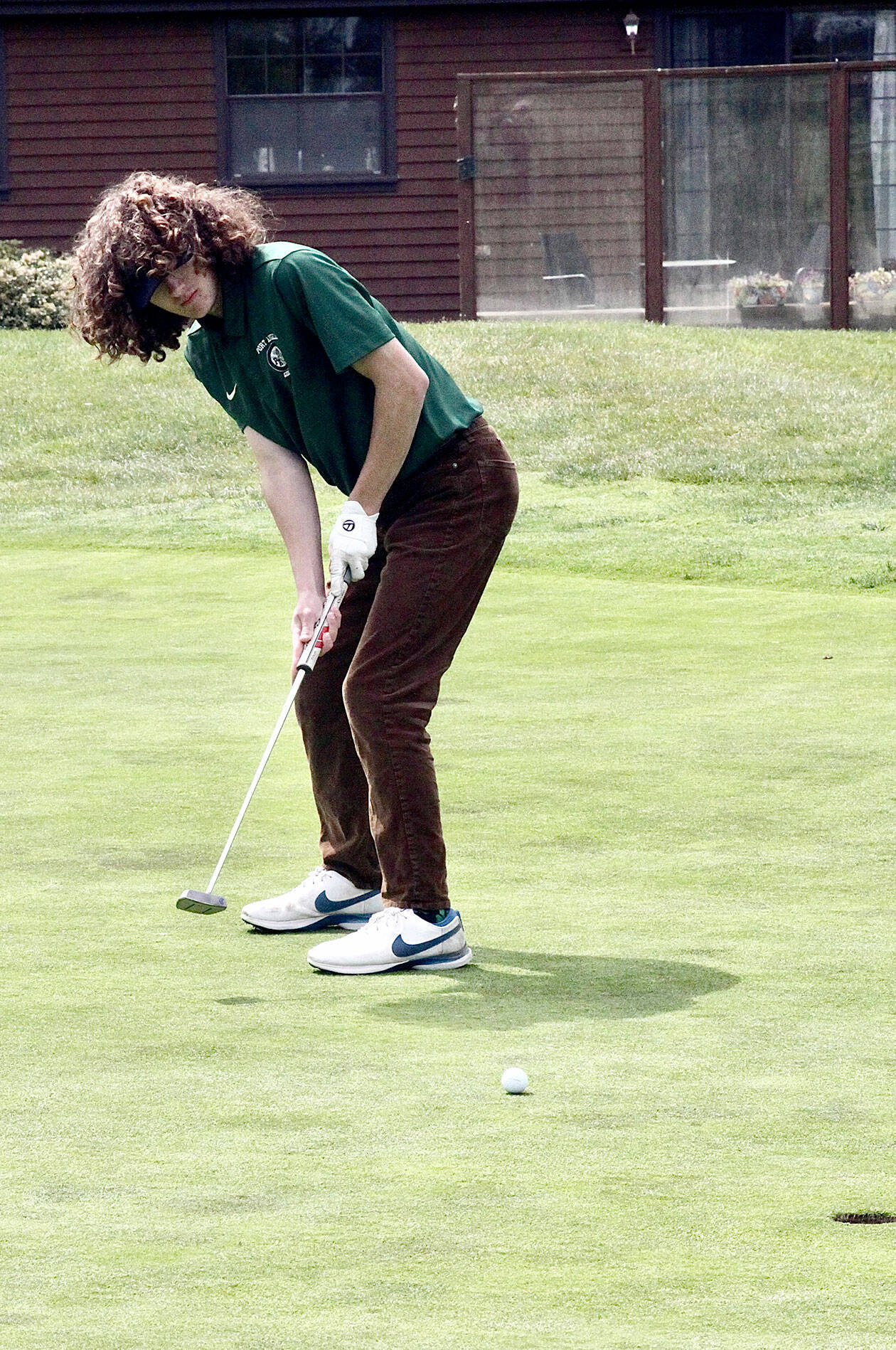 Port Angeles’ Edun Bailey sinks a 10-foot putt for a birdie on the fifth green at the Cedars at Dungeness course Tuesday. (Dave Logan/for Peninsula Daily News)