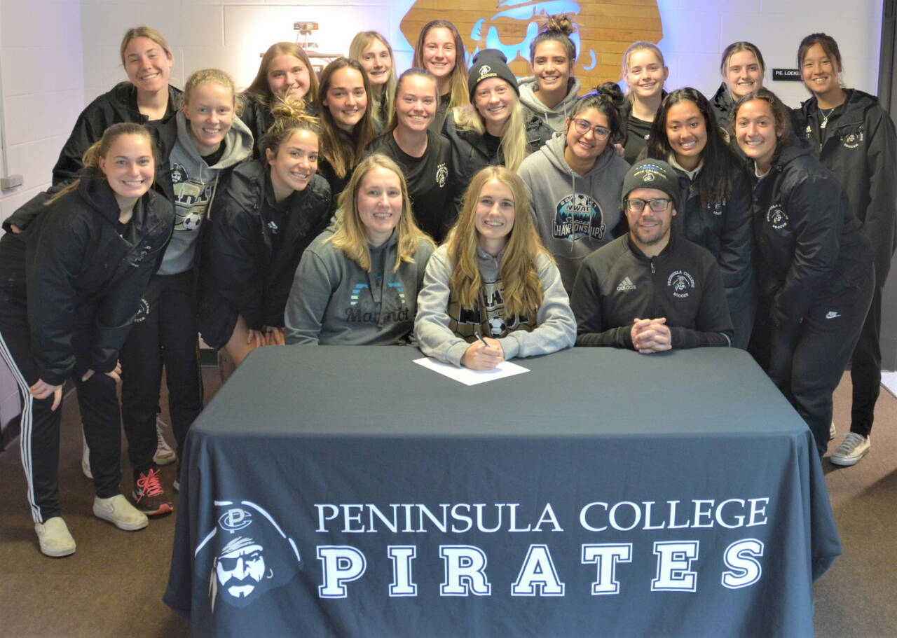 Sequim’s Hannah Wagner signs to play soccer for Peninsula College and poses with her teammates and coach Kanyon Anderson. (Peninsula College)