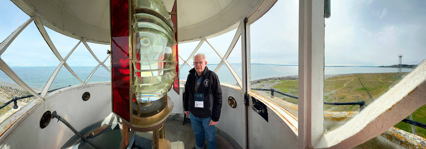 Dick Richardson, volunteer coordinator of the U.S. Light House Society, shows off the 1880’s French made fresnel lens at the top of the Point Wilson Light at Fort Worden State Park. The society is the caretaker of the lighthouse, under a license from the U.S. Coast Guard. Public tours are conducted from 11 a.m. to 4 p.m. on Saturdays and Sundays. Because of liability issues and Coast Guard regulations, the top floor, where the lens is located, will be off limits. (Steve Mullensky/for Peninsula Daily News)