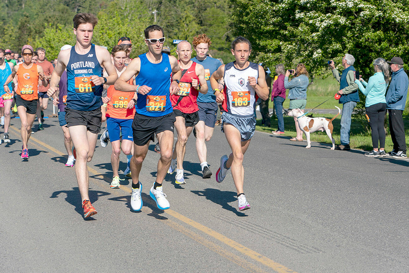 After a two-year hiatus, the Rhody Run took off again on Sunday in a new venue, the Jefferson County Fairgrounds. At the starting gun, the trio of Owen Chamberlain, from Tacoma, John Munro, from Port Townsend and the city manager, and Seamus Fraser, from Port Townsend, lead the pack around the 6.2-mile (10K) course. Fraser won the event with an official time of 35 minutes, 12.33 seconds. Munro was first in his age group of 45-49 and third overall with a time of 36:56.72. (Steve Mullensky/for Peninsula Daily News)