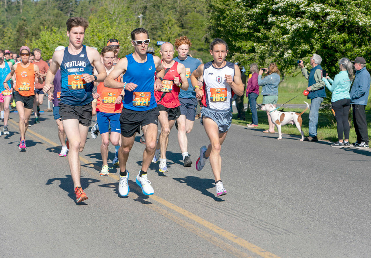 After a two-year hiatus, the Rhody Run took off again on Sunday in a new venue, the Jefferson County Fairgrounds. At the starting gun, the trio of Owen Chamberlain, from Tacoma, John Munro, from Port Townsend and the city manager, and Seamus Fraser, from Port Townsend, lead the pack around the 6.2-mile (10K) course. Fraser won the event with an official time of 35 minutes, 12.33 seconds. Munro was first in his age group of 45-49 and third overall with a time of 36:56.72. (Steve Mullensky/for Peninsula Daily News)