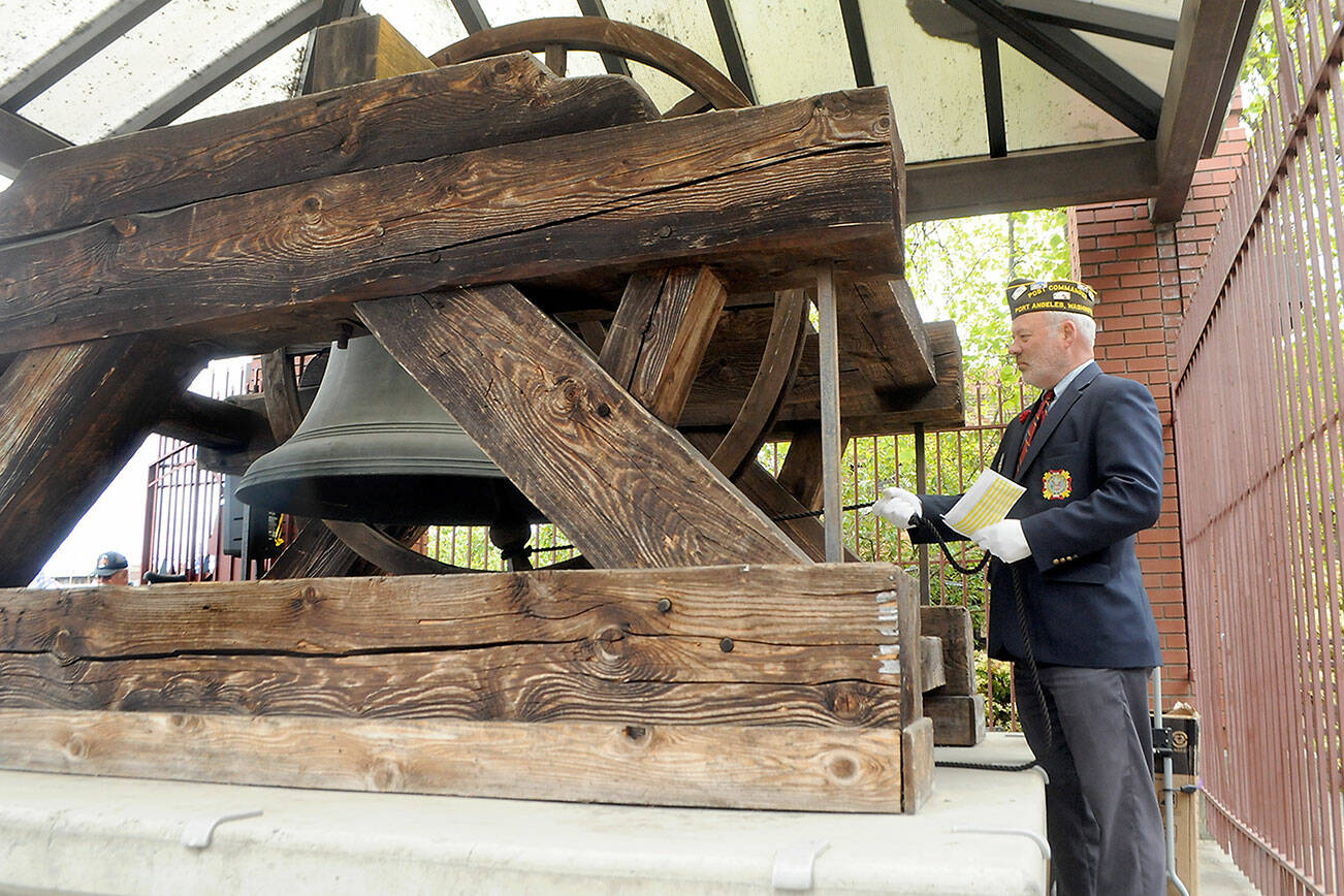 Keith Thorpe/Peninsula Daily News
John Kent, commander of VFW Post 1024 of Port Angeles, rings the Liberty Bell replica in honor of Clallam County veterans who have died in the previous month during the monthly rememberance ceremony on Friday at Veterans Park in Port Angeles. A total of 29 veterans were recognized with a chiming of the bell for each.