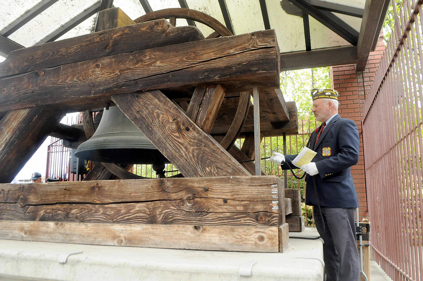 John Kent, commander of VFW Post 1024 of Port Angeles, rings the Liberty Bell replica in honor of Clallam County veterans who have died in the previous month during the monthly rememberance ceremony on Friday at Veterans Park in Port Angeles. (Keith Thorpe/Peninsula Daily News)
