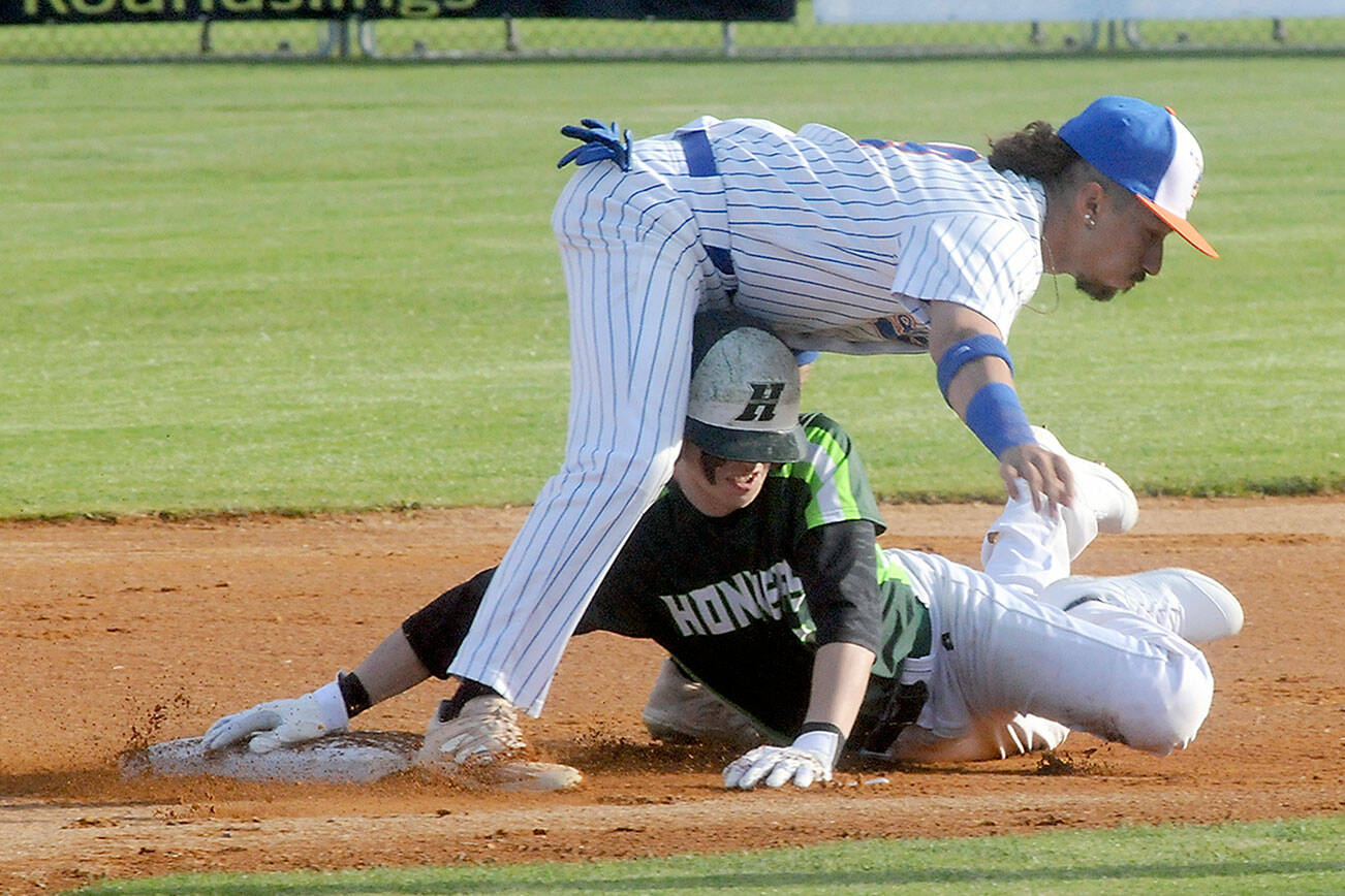 Keith Thorpe/Peninsula Daily News
Lefties second baseman Gabrial De Jesus, top, stuggles to keep his balance after tagging out Northwest's Jesse Bechtold on a steal attemp in the first inning on Friday evening at Port Angeles Civic Field.