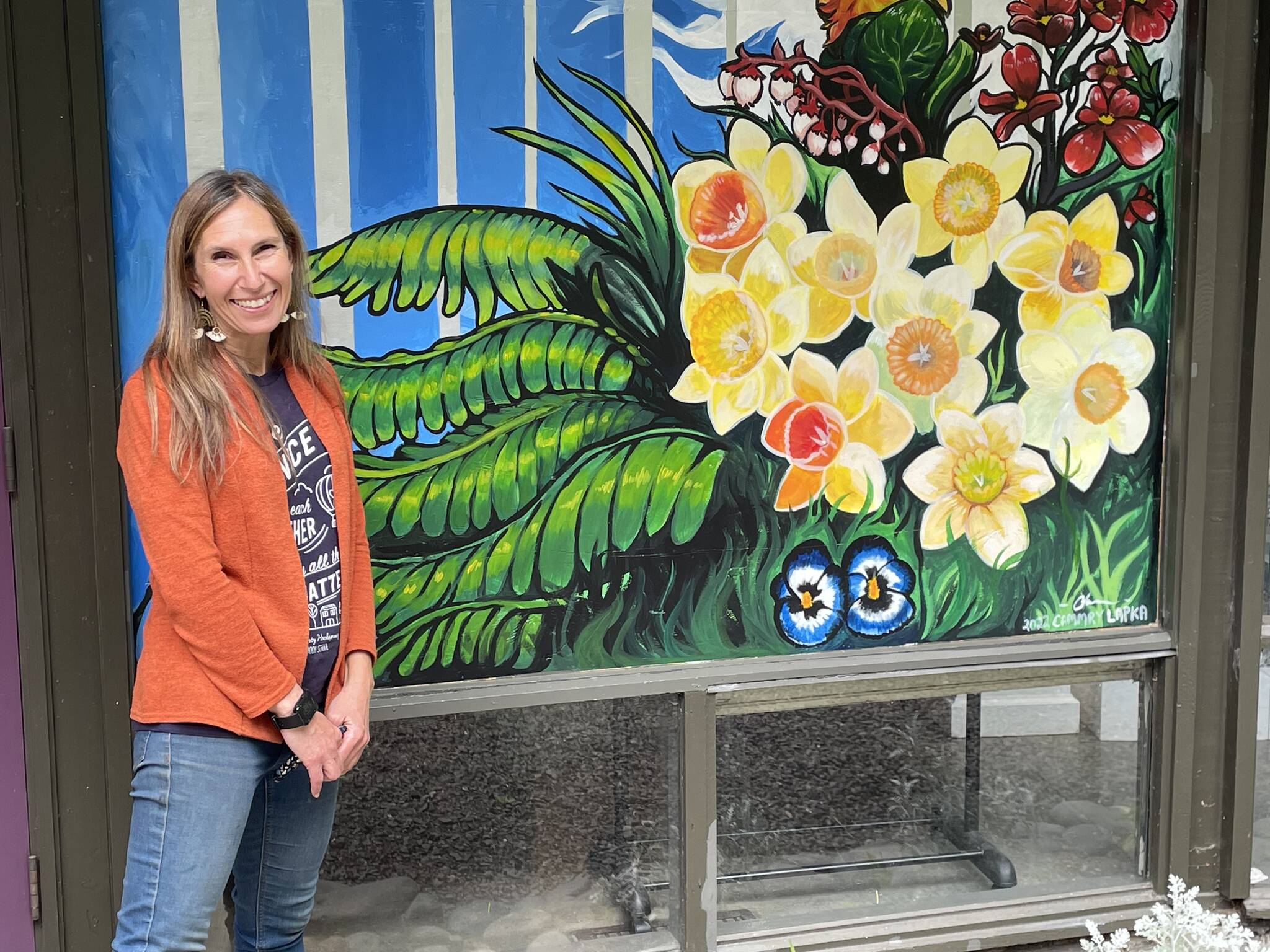 A bright mural created by Cammry Lapka covers the boarded over the space where a burglar broke a window, entered the Esther Webster Gallery at the Port Angeles Fine Arts Center, and stole items from a traveling exhibit. Christine Loewe, executive director of the Port Angeles Fine Arts Center, says that despite the seeming senselessness of the crime, that it was also an opportunity to bring the community together. (Paula Hunt/Peninsula Daily News)