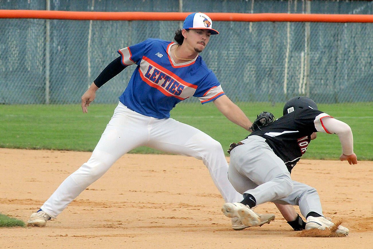 Keith Thorpe/Peninsula Daily News
Lefties shortstop Riley Parker tags out Kamloops baserunner Tommy Green during a steal attempt in the second inning of the first game of Saturday's double header in Port Angeles.