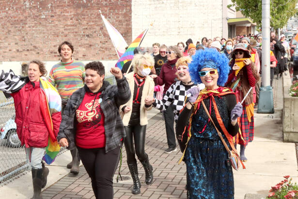 The Pride Parade marches west on Front Street in downtown Port Angeles on Sunday. About 250 people marched in a six-block course back to the City Pier as participants chanted repeated words of Pride acceptance. (Dave Logan/for Peninsula Daily News)