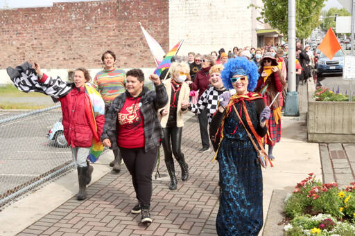 The Pride Parade marches west on Front Street in downtown Port Angeles on Sunday. About 250 people marched in a six-block course back to the City Pier as participants chanted repeated words of Pride acceptance. (Dave Logan/for Peninsula Daily News)