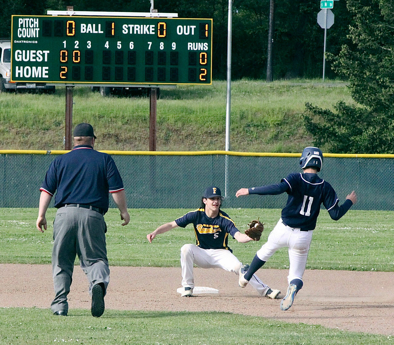 Dave Logan/for Peninsula Daily News Westport’s Rylan Politika slides into second base but is met by Forks’ shortstop Dylan Micheau with the ball already in his glove for the out during the Olympic Junior Babe Ruth Championship at Volunteer Field.