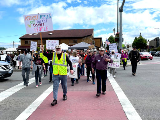 Demonstrators in Sequim demand an end to gun violence and call for lawmakers to take action on stricter firearm laws as part of the nationwide March for Our Lives protests Saturday. (Paula Hunt/Peninsula Daily News)
