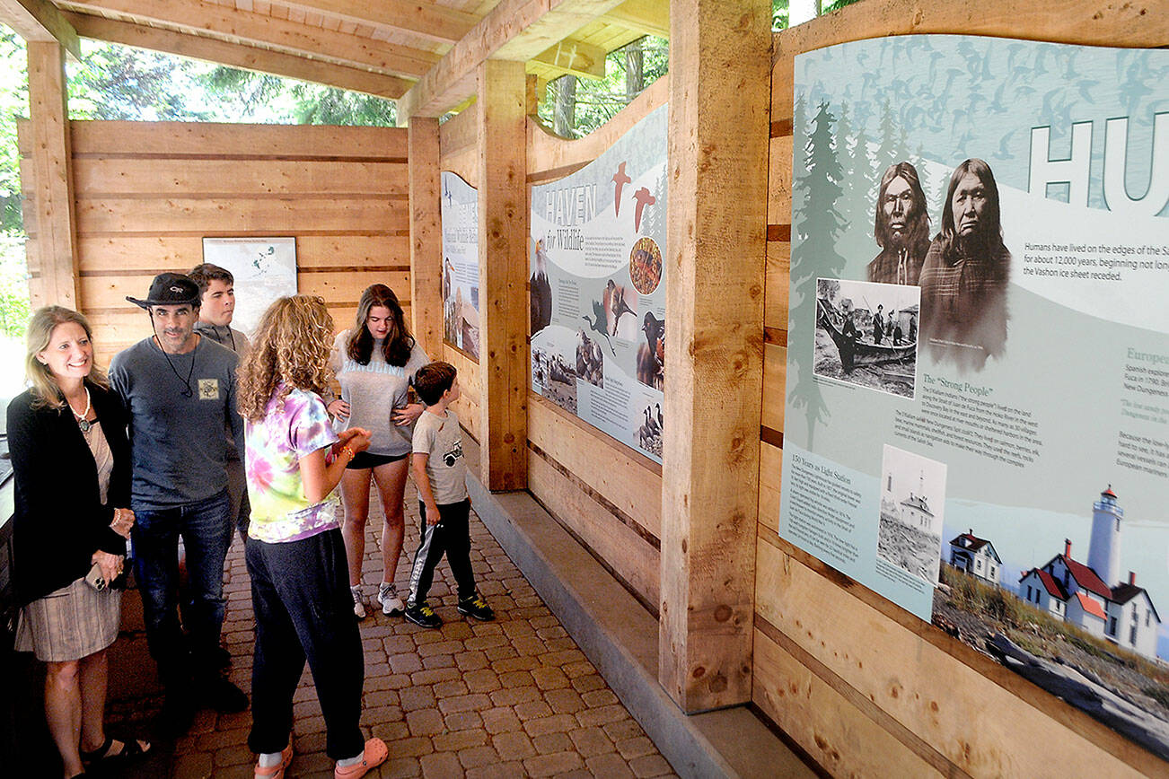 Keith Thorpe/Peninsula Daily News
Members of the Polge family from Raleigh, N.C., from left, parents Tami and Steven, and siblings Sebastian, 18, Anna, 15, Christina, 18, and Nico, 7, exmaine an informational display at the Dungeness National Wildlife Refuge north of Sequim on Thursday. The refuge is sanctuary to a variety of Northwest wildlife and serves as the access point to the Dungeness Spit and the New Dungeness Lighthouse.