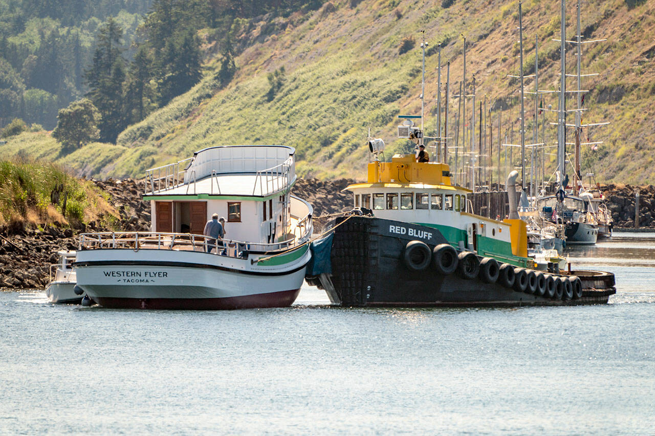 The tug Red Bluff moves the Western Flyer out of the Port Townsend Boat Haven on Thursday and was towed to Seattle for the installation of an engine and other components. (Steve Mullensky/for Peninsula Daily News)