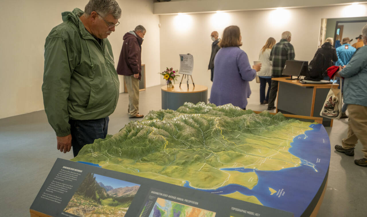 Visitors get a look at the Dungeness River Nature Center’s 3-D Dungeness River watershed table relief map. The center hosts open houses this week. (John Gussman/Jamestown S’Klallam Tribe)