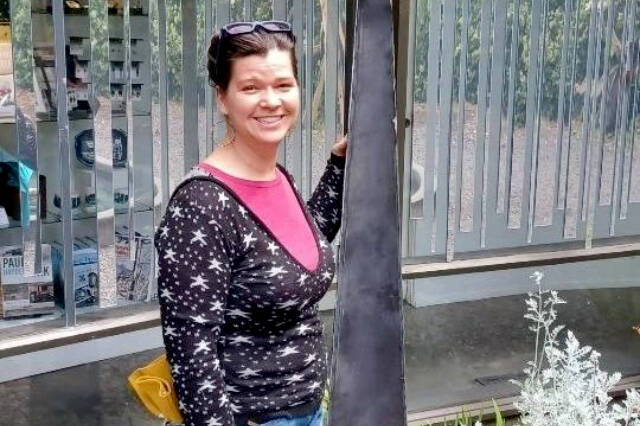 Karen Sixkiller poses with her Water Spider sculpture.