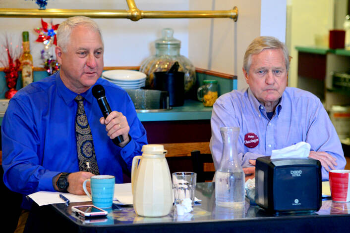 Brian Pruiett, a Republican candidate for state House of Representatives District 24, Position 2, left, speaks during a candidate debate at Joshua’s Restaurant in Port Angeles on Tuesday. Pruiett is challenging incumbent Steve Tharinger, a Democrat who’s held the seat since 2010, seated at right. (Peter Segall/Peninsula Daily News)