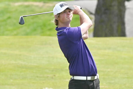 Sequim’s Ben Sweet watches his iron shot during a match with North Kitsap this spring. Sweet has been named the Peninsula Daily News’ All-Peninsula Golf MVP. (Michael Dashiell/Olympic Peninsula News Group)