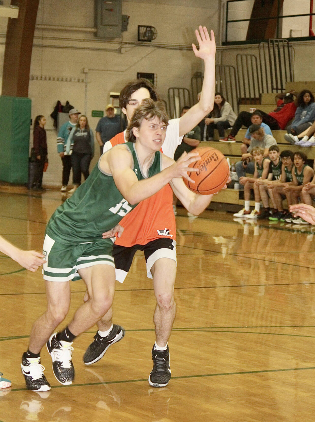 Port Angeles’ Parker Nickerson muscles his way to the basket around a Central Kitsap defender during the Port Angeles summer basketball tournament Sunday. (Dave Logan/for Peninsula Daily News)
