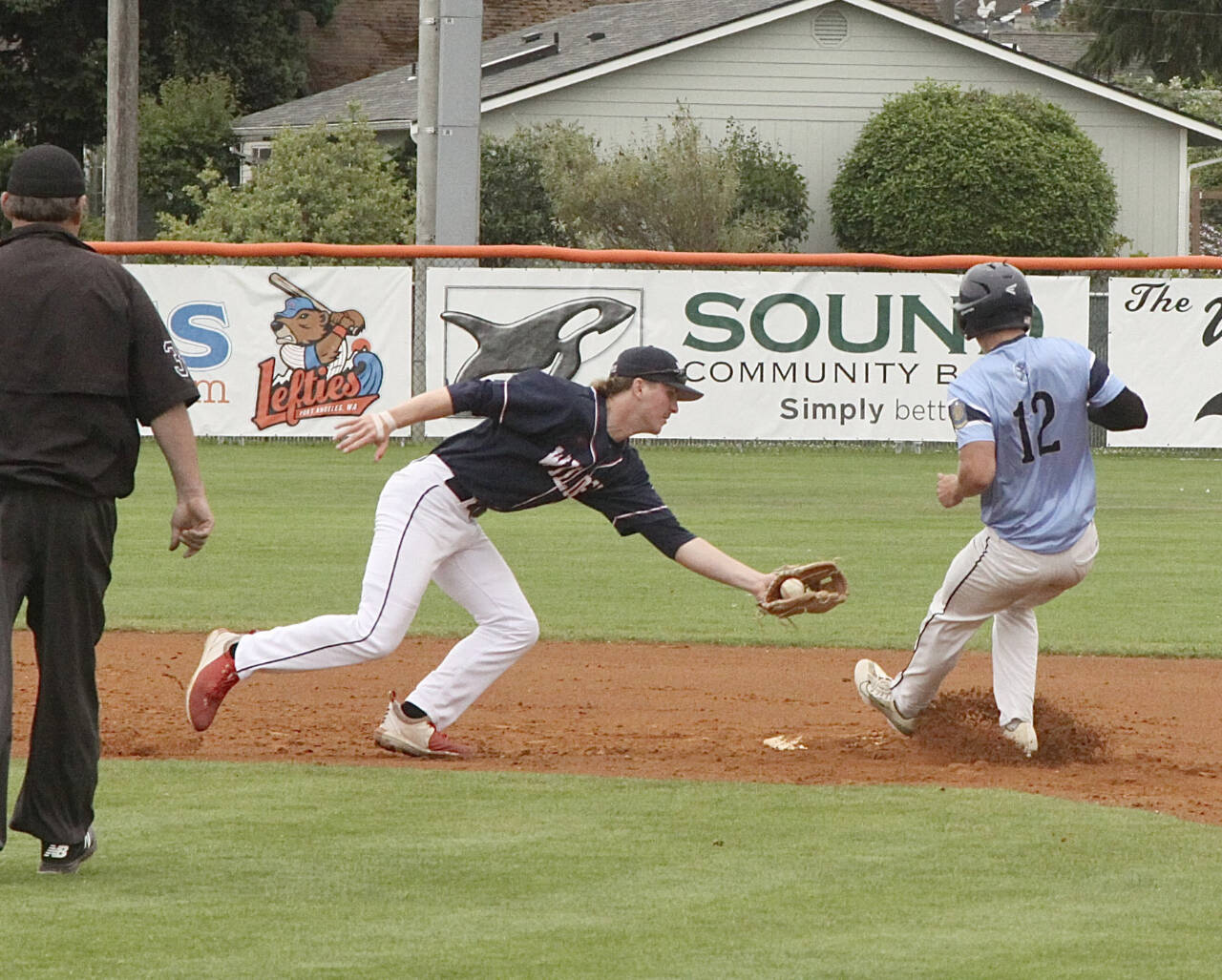 Wilder Sr.’s Wyatt Hall, with ball, tries to tag out a Bellingham Post No. 7 baserunner at second base at Civic Field on Monday. (Dave Logan/for Peninsula Daily News)