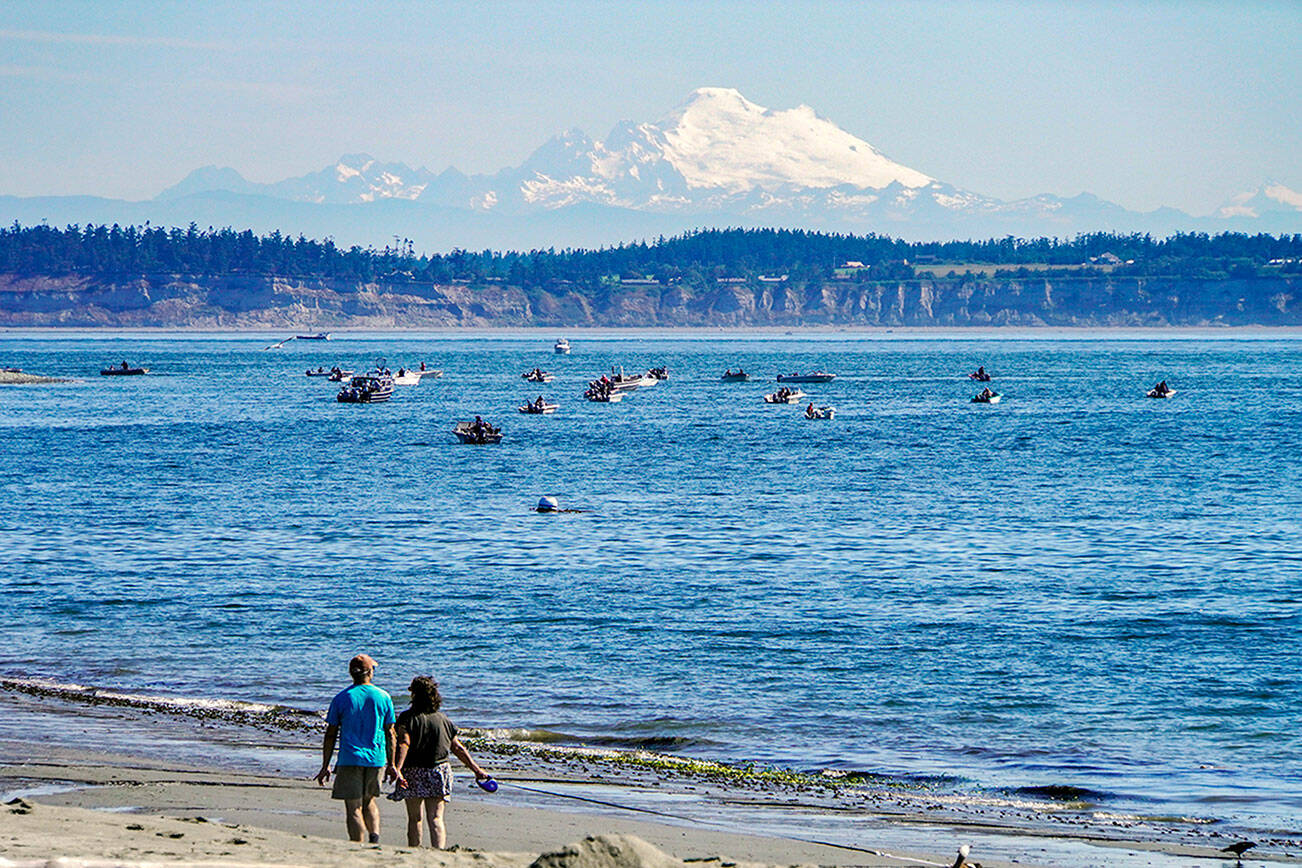 Steve Mullensky/for Peninsula Daily News

Mount Baker shines in morning sunshine last week as dozens of fishermen try their luck in the waters off the Point Wilson Light House.  Fishing is also open this week from Thursday through Saturday.