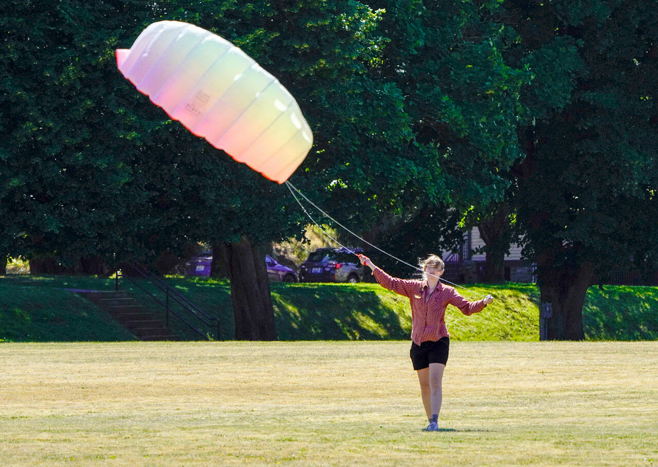 Amelia Grant, from Port Townsend, loses air in the canopy of the high performance kite she was flying on the parade ground at Fort Worden State Park on Tuesday. A brisk wind blew in from the west and made for perfect kite flying weather. (Steve Mullensky/for Peninsula Daily News)