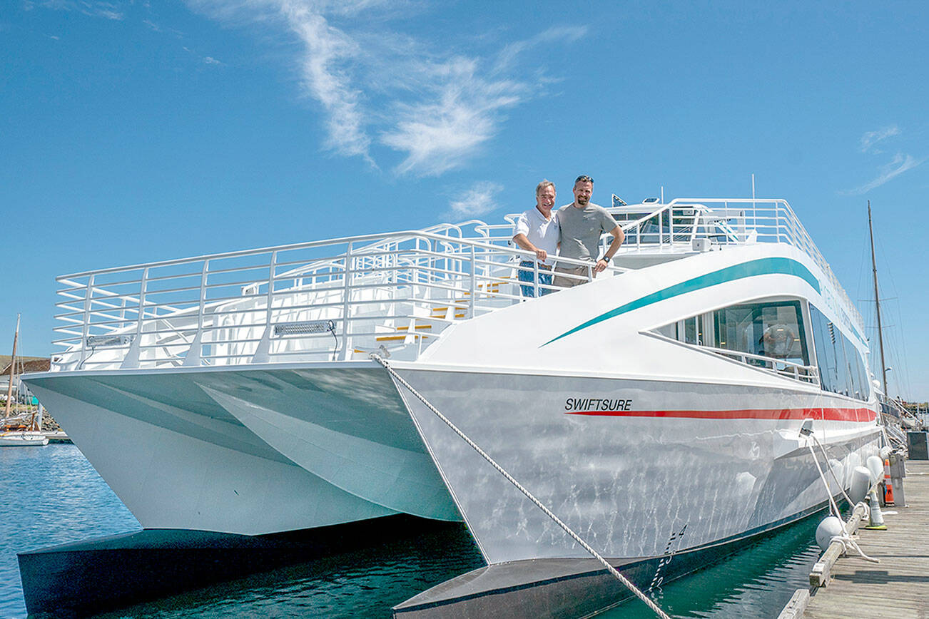 Steve Mullensky/for Peninsula Daily News

Pete Hanke (left) and son Chris, with Puget Sound Express, the 37 year old whale watching tour company based in Port Townsend, stand on the the bow of their new 77 foot tour boat, Swiftsure, while it is being fitted out at Point Hudson Marina on Thursday. The swiftsure will carry up to 145 passengers around the Salish Sea.