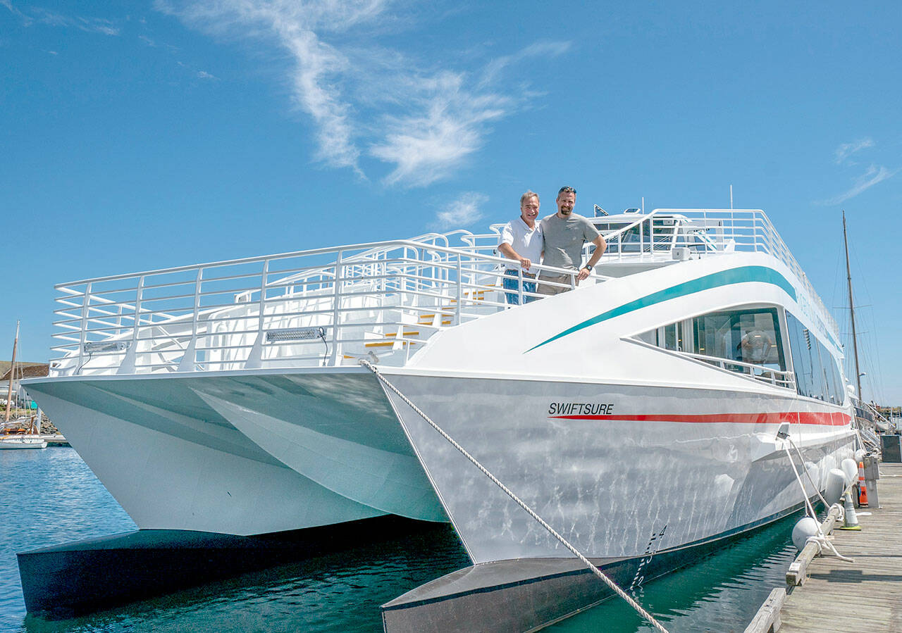 Steve Mullensky/for Peninsula Daily News
Pete Hanke (left) and son Chris, with Puget Sound Express, the 37 year old whale watching tour company based in Port Townsend, stand on the the bow of their new 77 foot tour boat, Swiftsure, while it is being fitted out at Point Hudson Marina on Thursday. The swiftsure will carry up to 145 passengers around the Salish Sea.