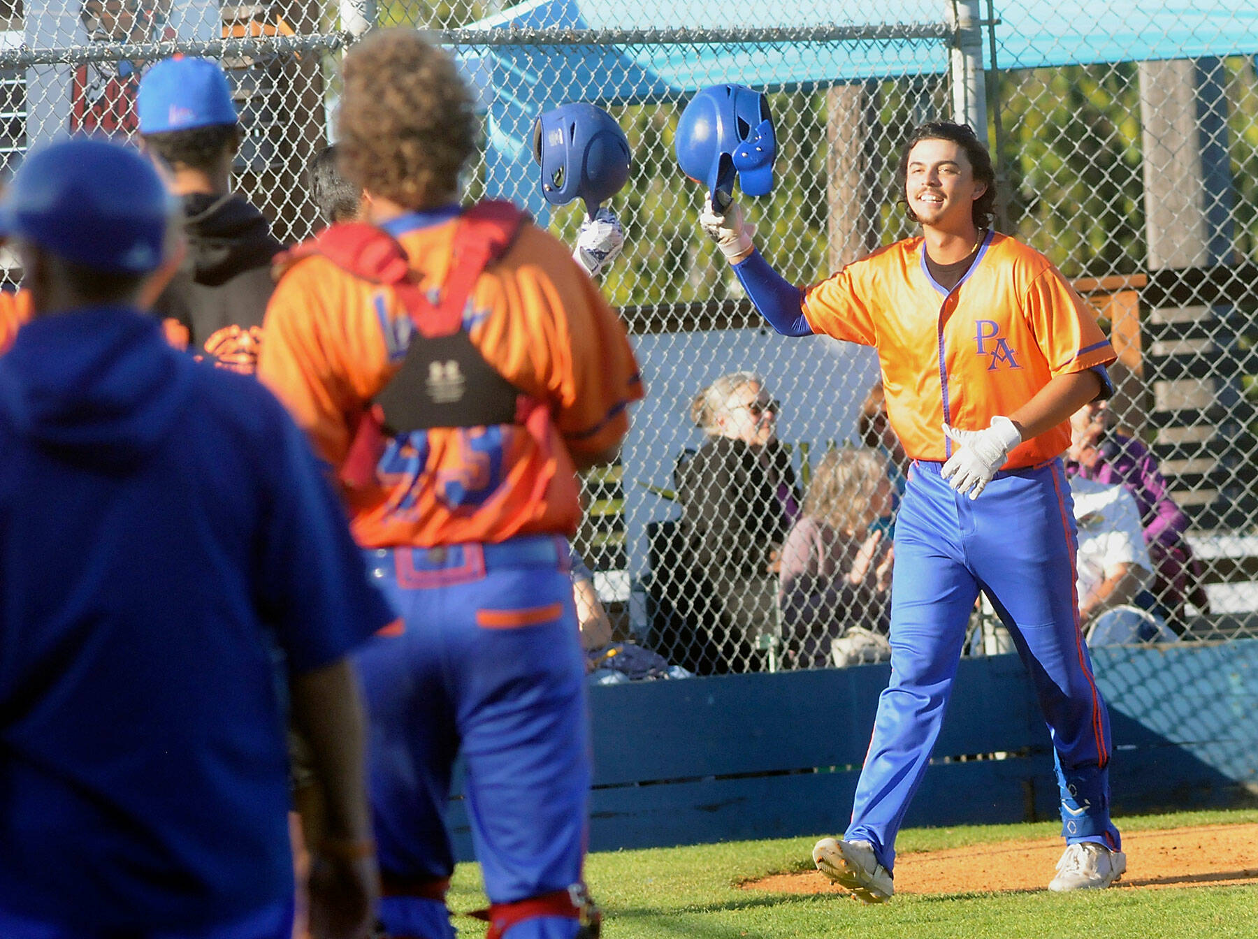 Keith Thorpe/Peninsula Daily News
Lefties designated hitter Riley Parker tips his helmet at his teammates after rounding the bases with a solo homer in the first inning on Thursday night at Port Angeles Civic Field.