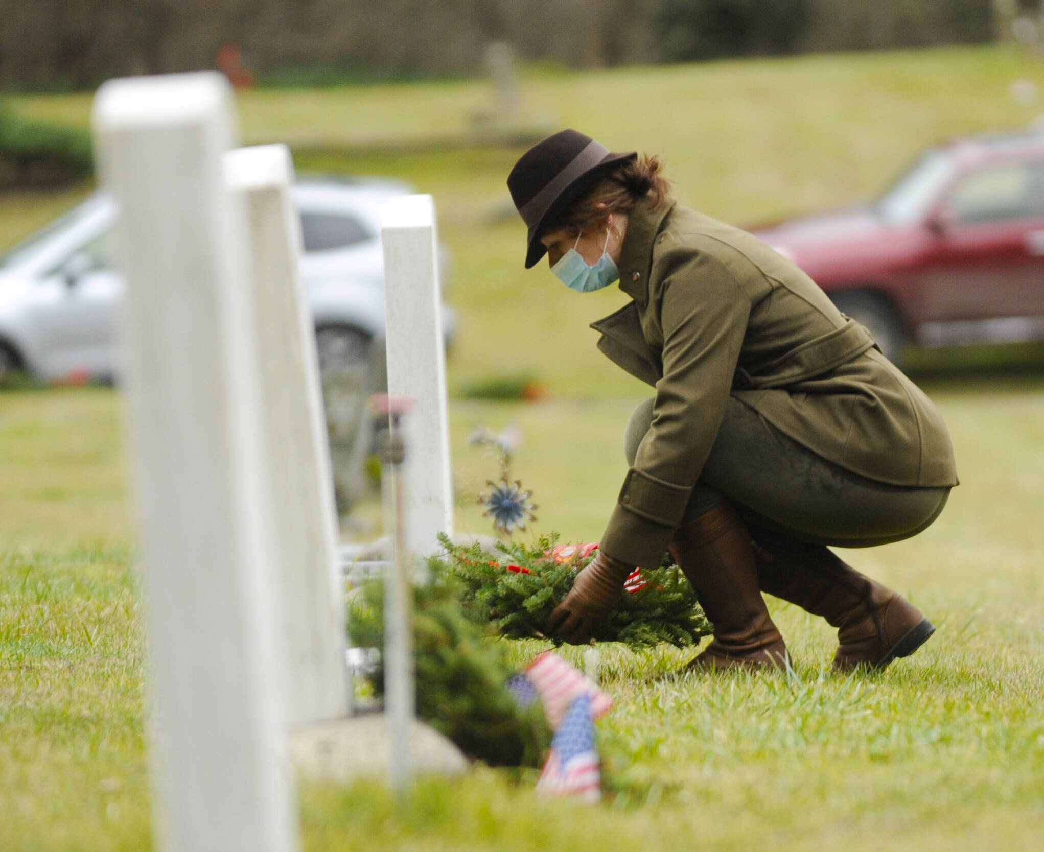 Michael Dashiell/Olympic Peninsula News Group 
Lance Cpl. Holly Rowan, a U.S. Marine Corps veteran, lays a ceremonial wreath at a Wreaths Across America event at Sequim View Cemetery on Dec. 19, 2020.