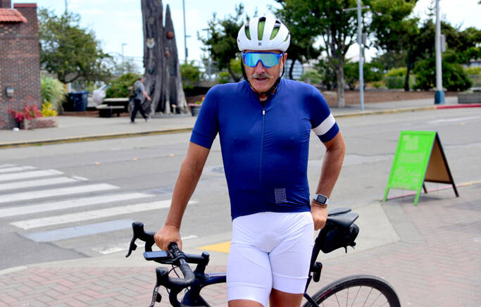 Cyclist Pete Lietz stops in Port Angeles on Monday as he neared the end of his more than 6,000-mile bike ride across the continental U.S. Lietz said the COVID-19 pandemic motivated him to follow through on something he’d only thought about, and he’s using the opportunity to raise money for men’s health. (Peter Segall / Peninsula Daily News)
